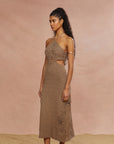 This image presents the Clara Midi Knit Dress, designed with a halter neck and sleeveless silhouette. The dress is crafted from a fully lined, imported knit fabric that requires dry cleaning.