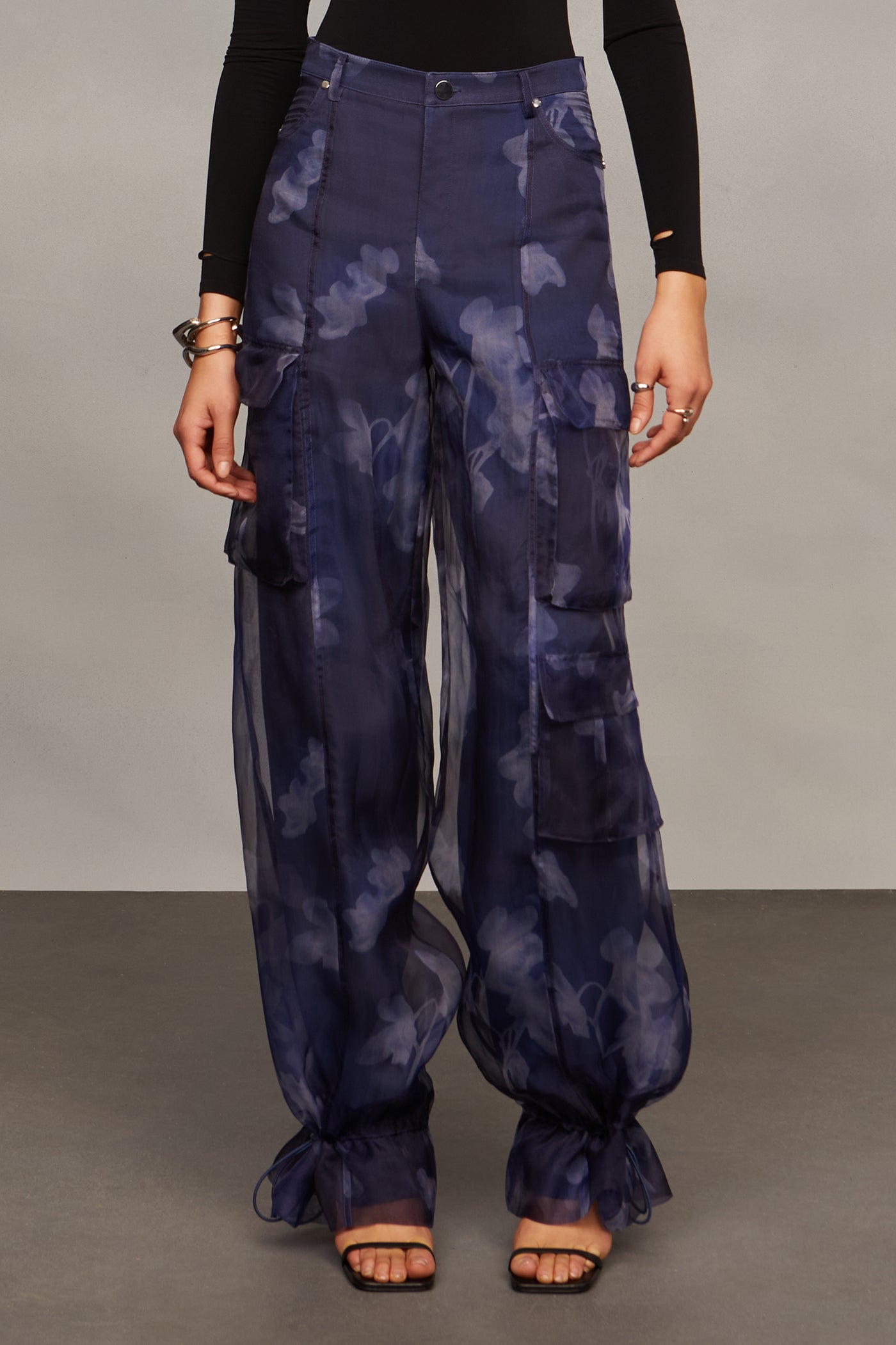 Person wearing dark blue camouflage pants on a gray background