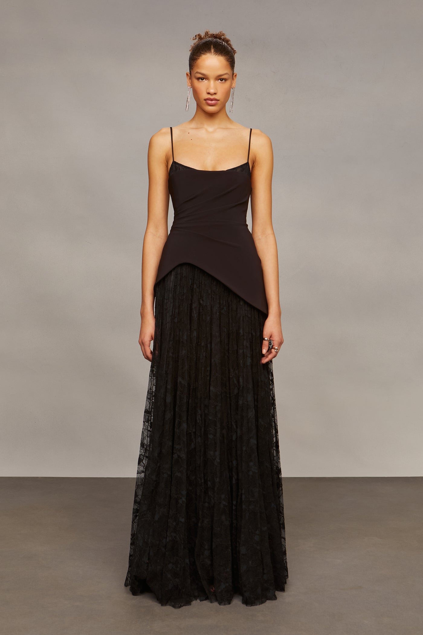 Woman wearing a black dress with a plain background