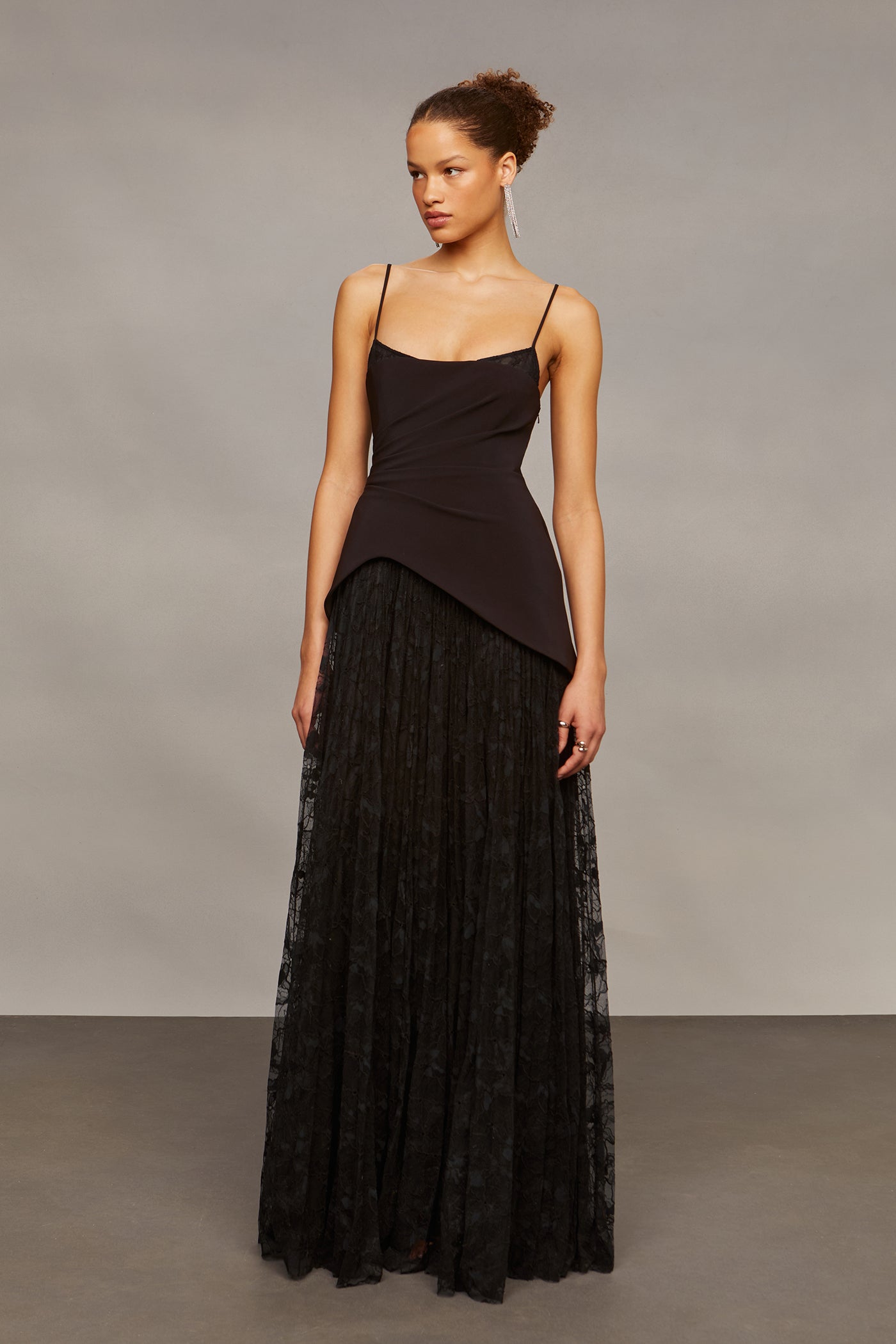 Woman wearing a black dress with a plain background